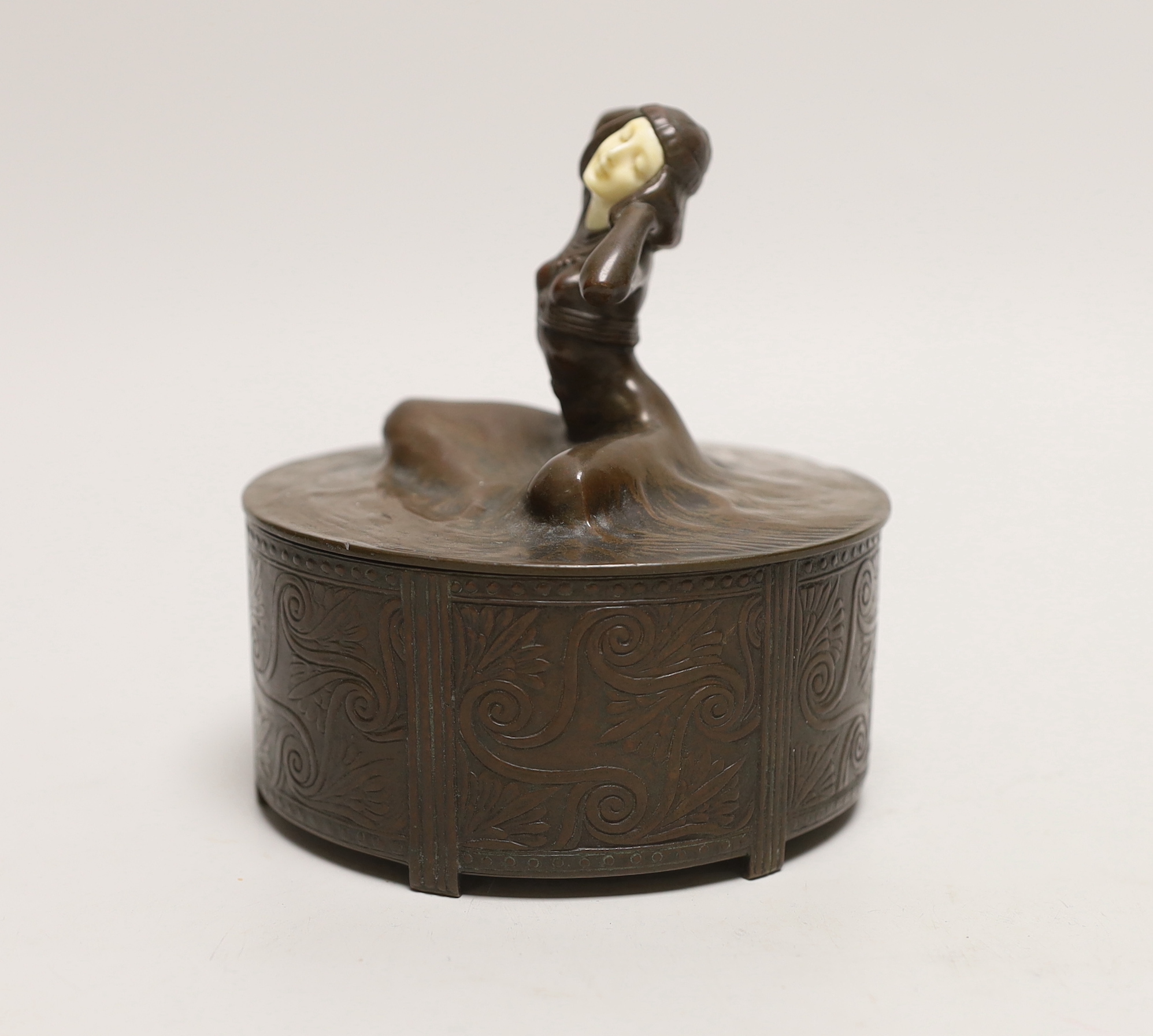 An Art Deco bronze and ivory circular box and cover, 12cm. Ivory Submission reference JQQU4ECR